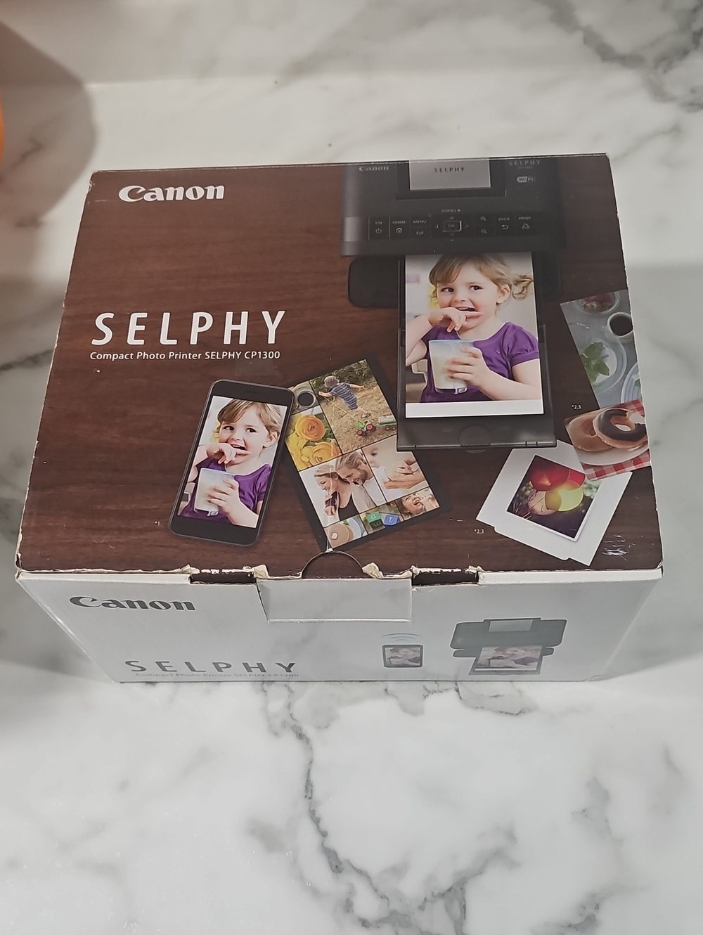 Canon SELPHY Compact Photo Printer CP1300 in brown and white packaging